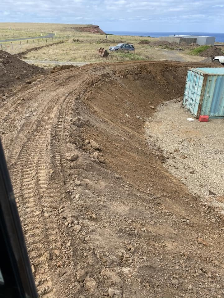 Excavator loading truck on earthmoving job