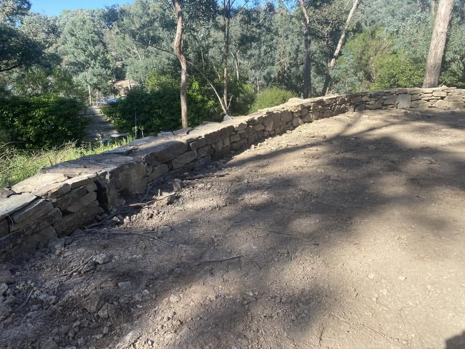 Concrete sleeper retaining wall with lawn